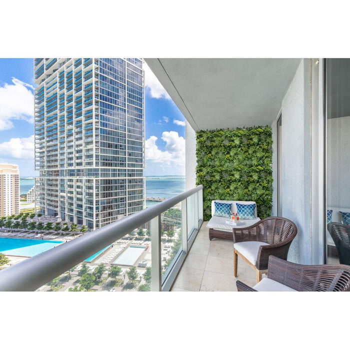 Premium Fern Artificial Green Wall Panel with Flowers on a Balcony in Miami