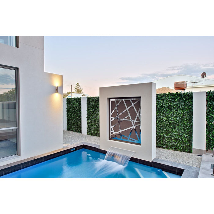 Artificial Ivy Plant Wall Panel Installed along a fence behind a pool