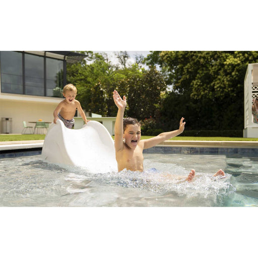 Children having fun with small pool water slide