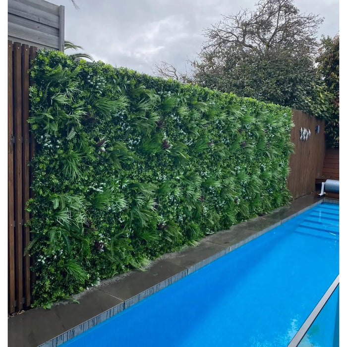 Premium Artificial Vertical Garden Panel Vista Green Installed Along a Pool onto a Fence