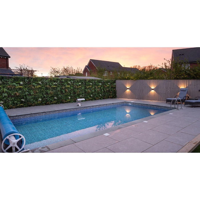 Swimming Pool with wild tropics living wall panel and yellow flowers added in