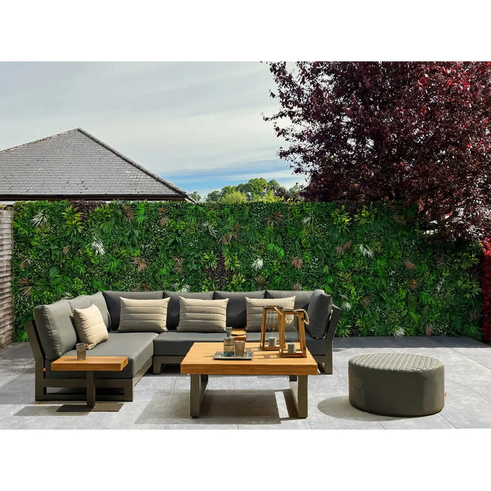 Backyard renovation with plastic plant wall panels and extra foliage added into the panels