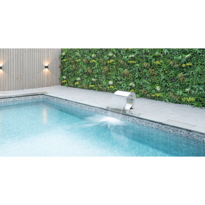 Plastic plant wall panel with foliage along a pool