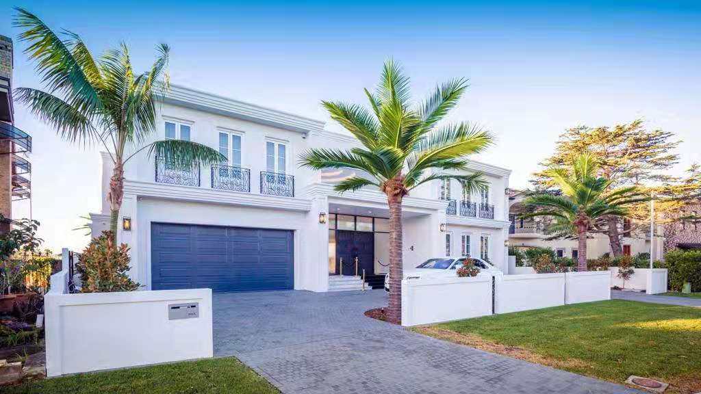 Large UV-resistant artificial palm trees installed outdoors at a luxury home