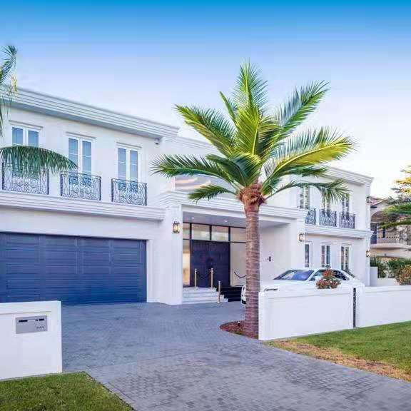 Large UV-resistant artificial palm trees installed outdoors at a luxury home