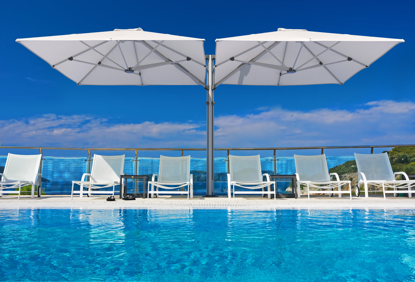 Shadowspec Unity Duo cantilever umbrella with dual square canopies shading an outdoor dining area on a coastal deck