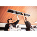 Two workers installing a ceiling recessed Bromic Platinum electric heater on a wooden ceiling.