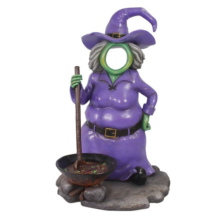 Purple witch figurine photo op with a broom and cauldron on a white background