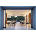 Modern indoor dining area with large glass doors and 6 Bromic Heaters recessed into the ceiling, leading to an outdoor garden.