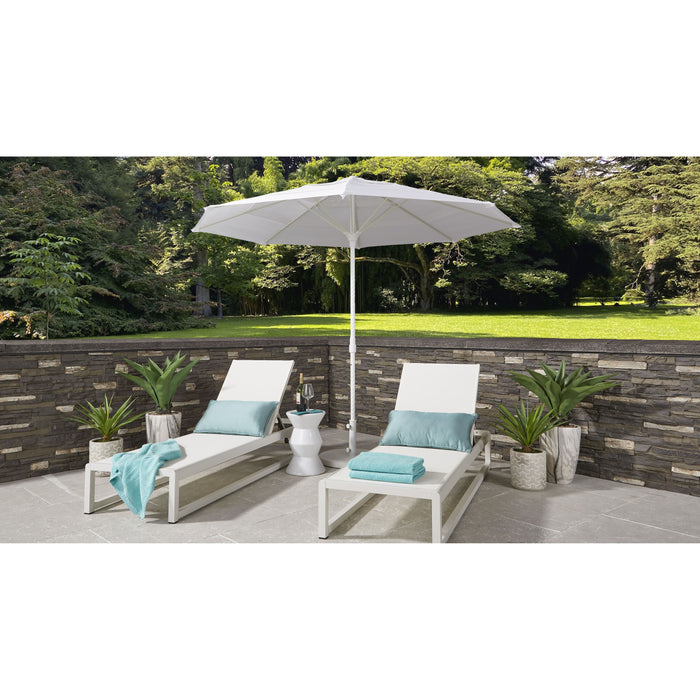 Two white lounge chairs with blue cushions under a large white Helux umbrella on a patio.