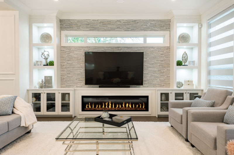Modern living room with a fireplace, TV, and decorative shelves.