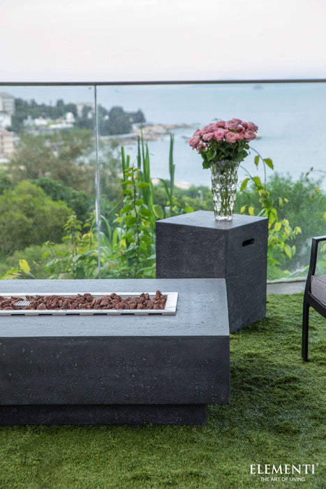 Outdoor setting with a fire pit and floral arrangement, featuring the Elementi brand.