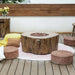 Outdoor setting with a wooden fire pit table and seating on a wooden deck.