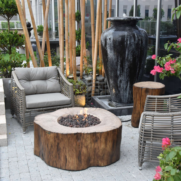 Outdoor patio with fire pit, chairs, and decorative elements