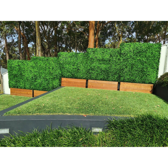 Artificial boxwood hedge installed onto a timber planter base outdoors