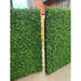 Faux Boxwood hedge panels installed onto a fence