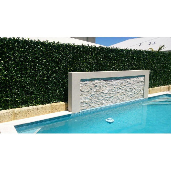 Artificial Hedge Panels Along a Pool Fence Wall