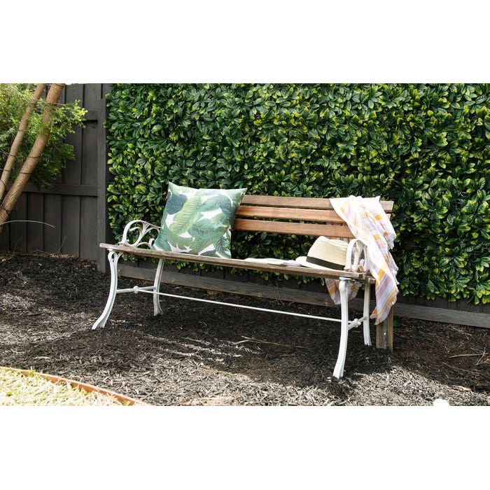 Artificial Large Ficus Leaf Hedge Panel along a timber fence and outdoor chair