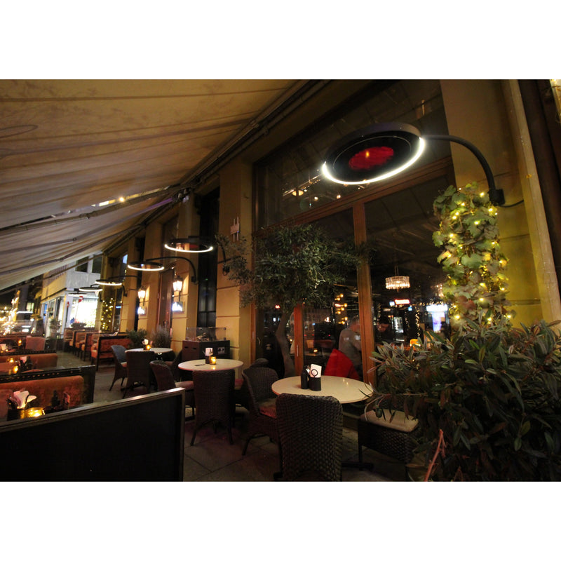 Exterior of a restaurant with tables, chairs, and decorative lighting from the Bromic Eclipse Heaters.