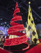 Red and gold spiral Christmas trees at a indoor event.