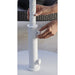 Person adjusting a white Helux umbrella stand on a light surface