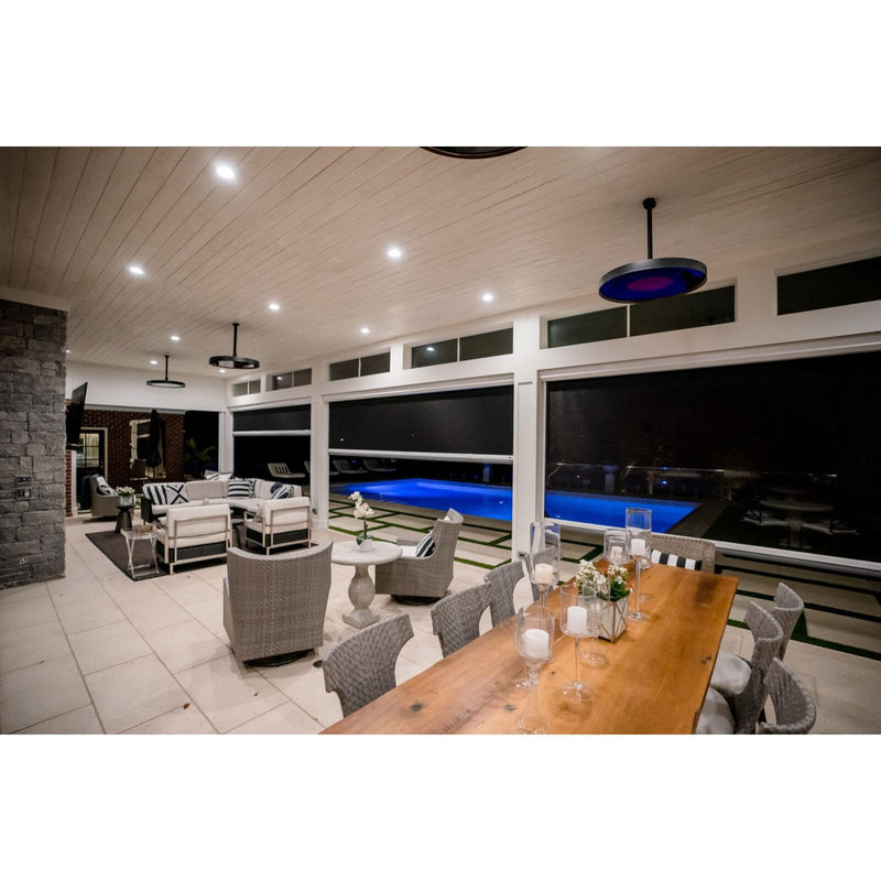 Bromic Eclipse Heaters in Modern indoor-outdoor living space with a pool, dining table, and chairs.