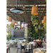 Modern restaurant interior with tables, chairs, and hanging Bromic Eclipse Heaters that are also being used as lights.