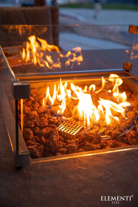 Close-up of a fire pit with flames and 'Elementi Fire' branding.