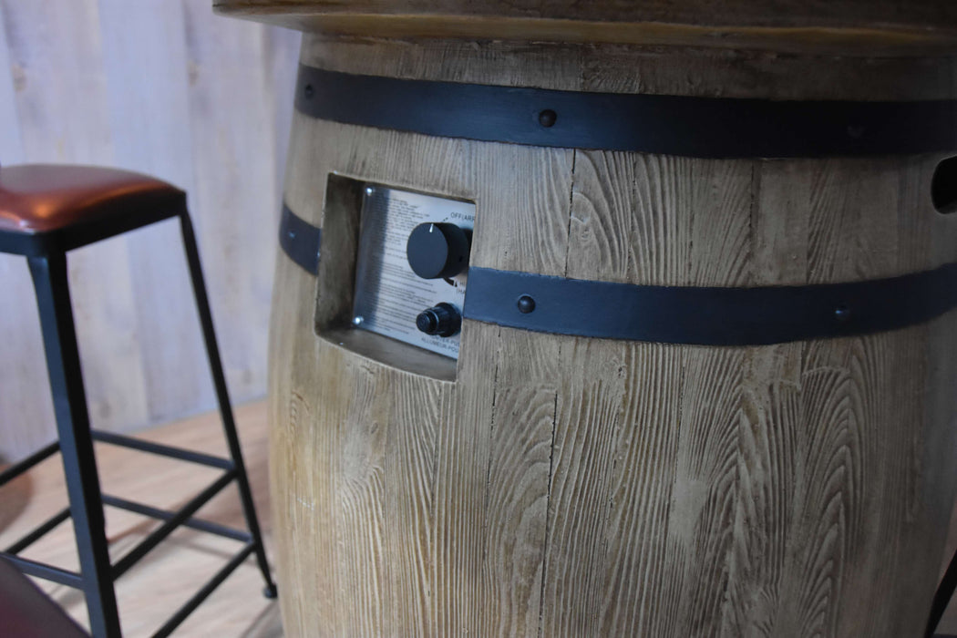 Elementi Lafite Wooden barrel table with a black strap and a stool in the background