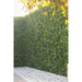 Artificial Boxwood Mat with Faux Flowers Installed Outdoors onto a Fence to enhance privacy