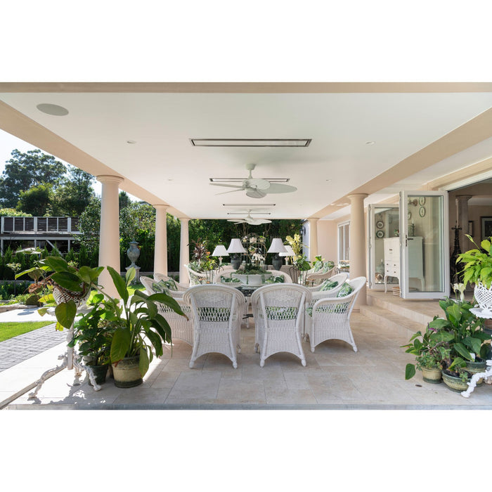 Outdoor patio with white wicker furniture, table, and potted plants.