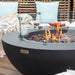Close up image of Elementi Lunar fire pit bowl table with flames and a cozy outdoor setting.