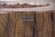 Elementi Manchester Wooden fire pit with 'Elementi' brand logo on a blurred natural background