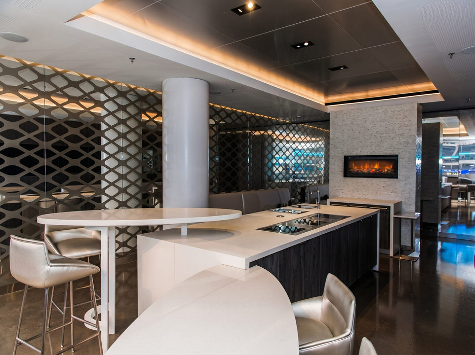 Modern kitchen with island and bar stools in a stylish interior setting.