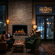 People sitting around a Orion V2 Traditional fireplace in a cozy restaurant named 'The Hearth & Grille'.