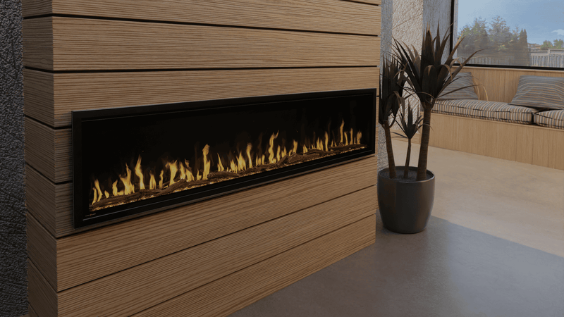 Modern electric fireplace embedded in a wooden wall with decorative plant and outdoor view.