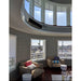 Modern living room with circular window design, a Bromic Platinum Electric Heater wall mounted above, and cityscape view