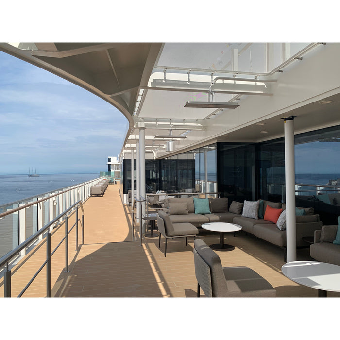 Cruise ship deck with seating area and ocean view