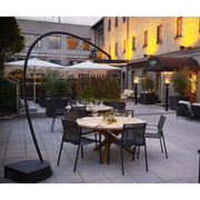Outdoor dining area with tables, chairs, and a building in the background