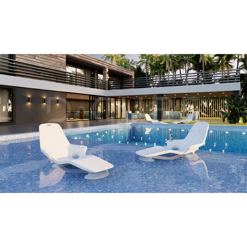 Modern poolside area with two Shayz lounge chairs pictured in a large pool with a house in the background