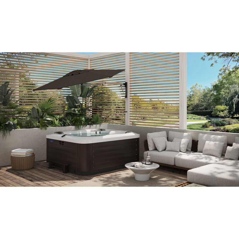 Rendered image of the Shadowspec Retreat wall mounted umbrella tilted and providing shade over a hot tub