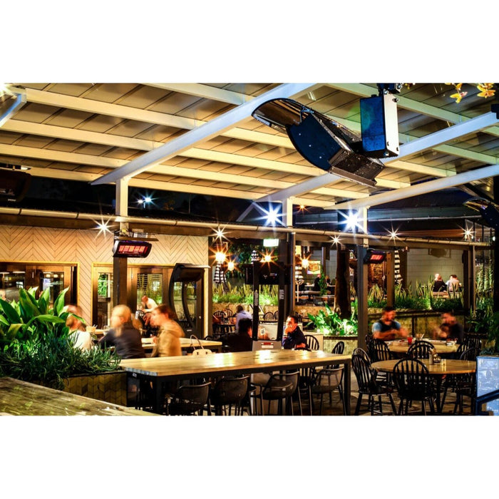 Interior of a restaurant with tables, chairs, and people dining.
