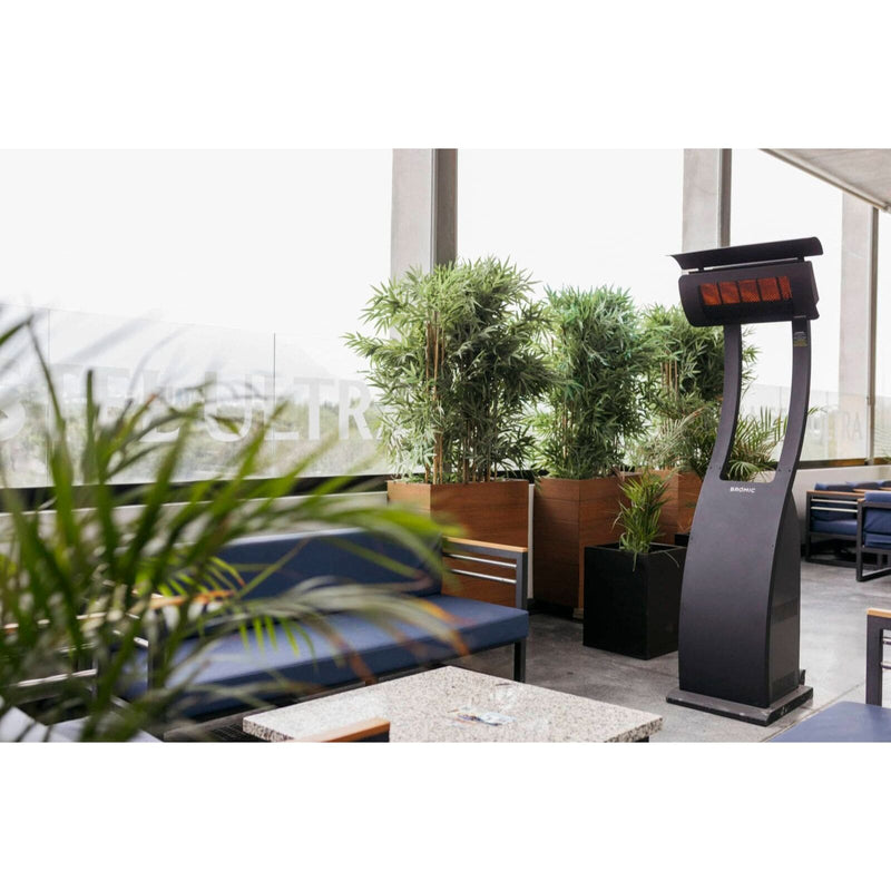 Outdoor seating area with a modern standing outdoor heater and plants