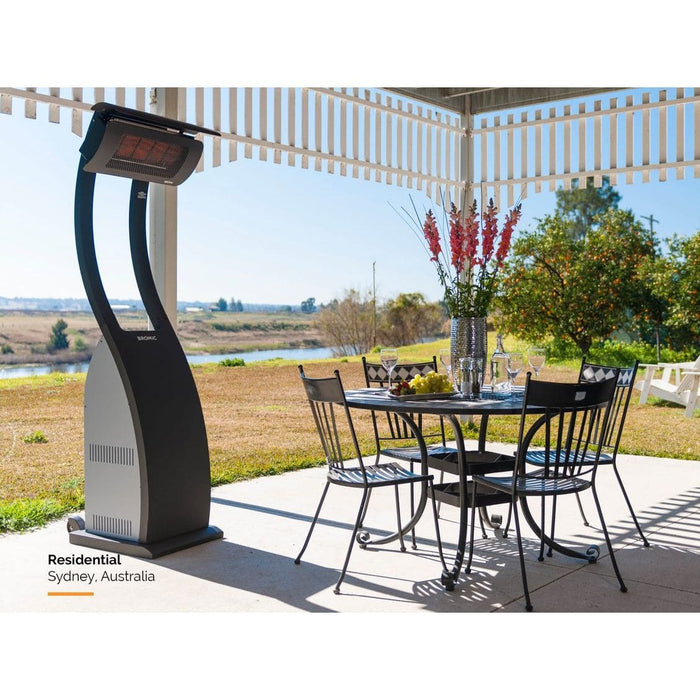 Outdoor patio with black metal table and chairs, infrared gas heater, and scenic background.