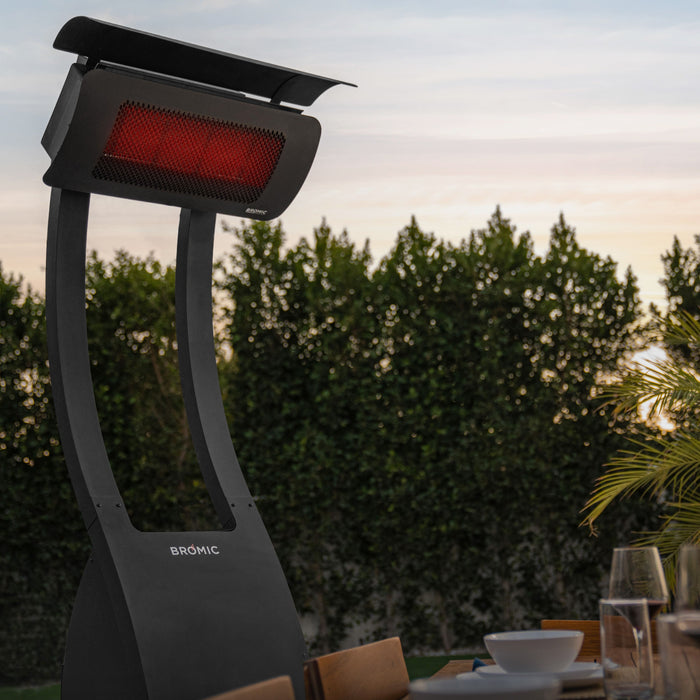 Outdoor Tungsten patio heater with trees and a table in the background