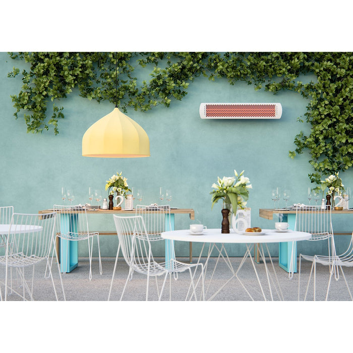 Outdoor dining area with tables, chairs, and a wall-mounted Bromic Heater