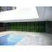 Artificial Vista Wall Panel for a Vertical Garden along a Pool in an Apartment Building