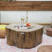 Wooden fire pit table with drinks and snacks on a patio setting