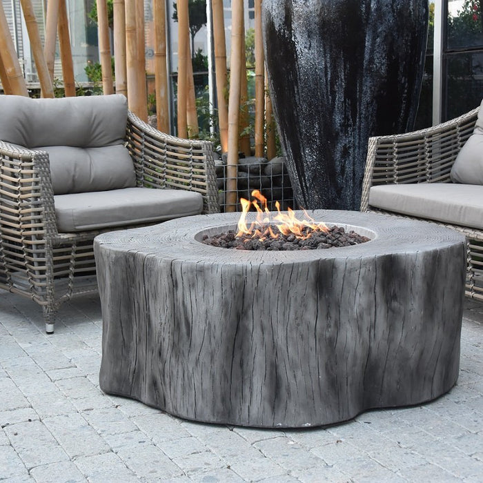 Outdoor patio setting with wicker chairs and a Elementi Manchester fire pit table.