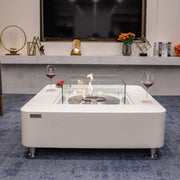 Modern living room with a Cream White fire pit table and Elementi branding.
